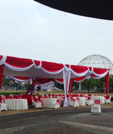 Area resepsi pernikahan dengan deretan meja di dalam tenda